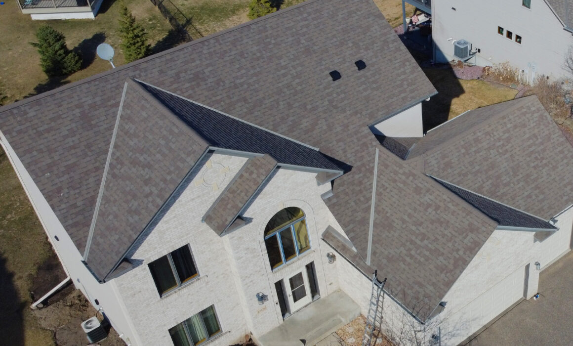Bird's-eye view of a residential property with a professionally installed asphalt shingle roof